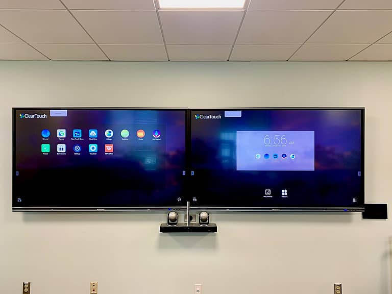 two tvs on the wall in an interactive learning environment classroom